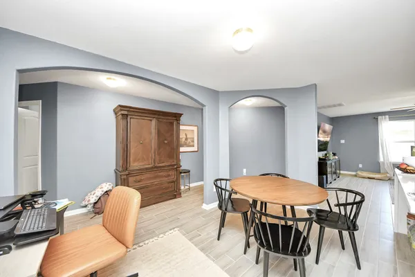 a view of a dining room with furniture and wooden floor