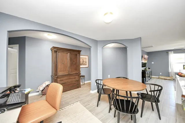 a view of a dining room with furniture and wooden floor