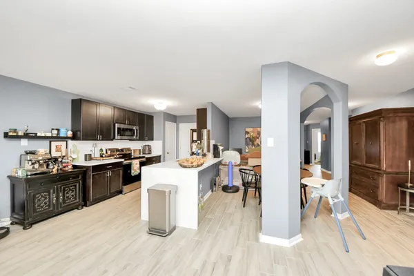 a kitchen with stainless steel appliances a sink stove top oven and cabinets