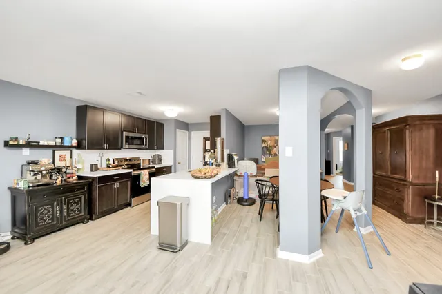 a kitchen with stainless steel appliances a sink stove top oven and cabinets