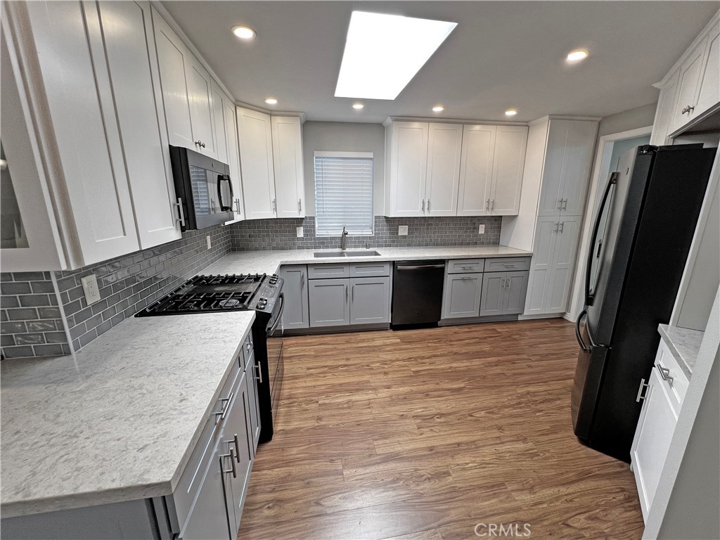 1352 Silver Lake Place, Unit 87 Brea, CA 92821 - Photo 11 of 51 a kitchen with stainless steel appliances granite countertop a refrigerator stove top oven and sink