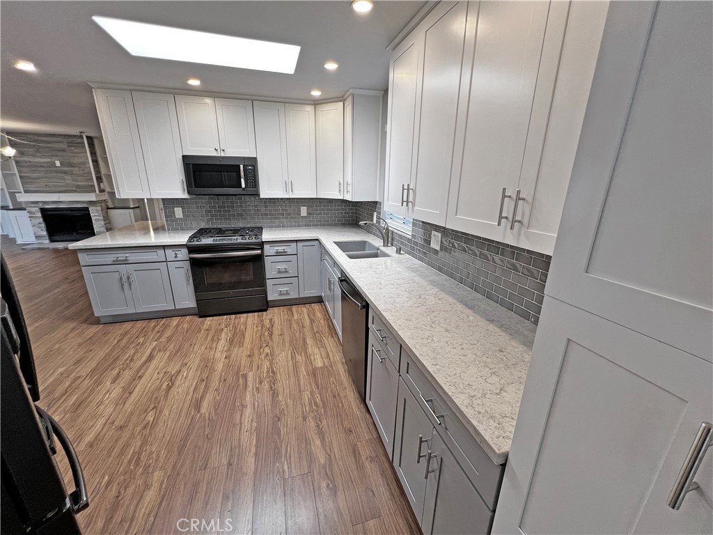 1352 Silver Lake Place, Unit 87 Brea, CA 92821 - Photo 12 of 51 a large kitchen with stainless steel appliances granite countertop a stove a sink and a refrigerator