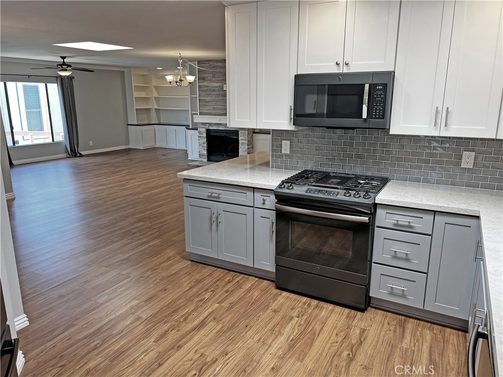1352 Silver Lake Place, Unit 87 Brea, CA 92821 - Photo 13 of 51 a kitchen with granite countertop a stove and a microwave