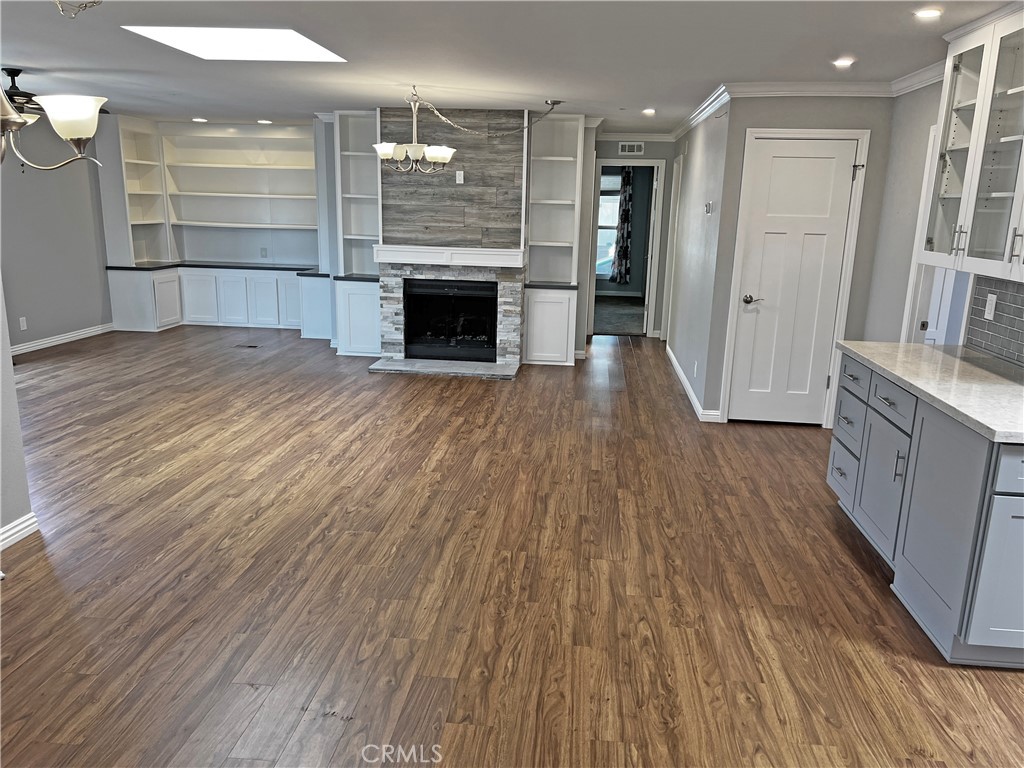 1352 Silver Lake Place, Unit 87 Brea, CA 92821 - Photo 15 of 51 an empty room with wooden floor and a fireplace