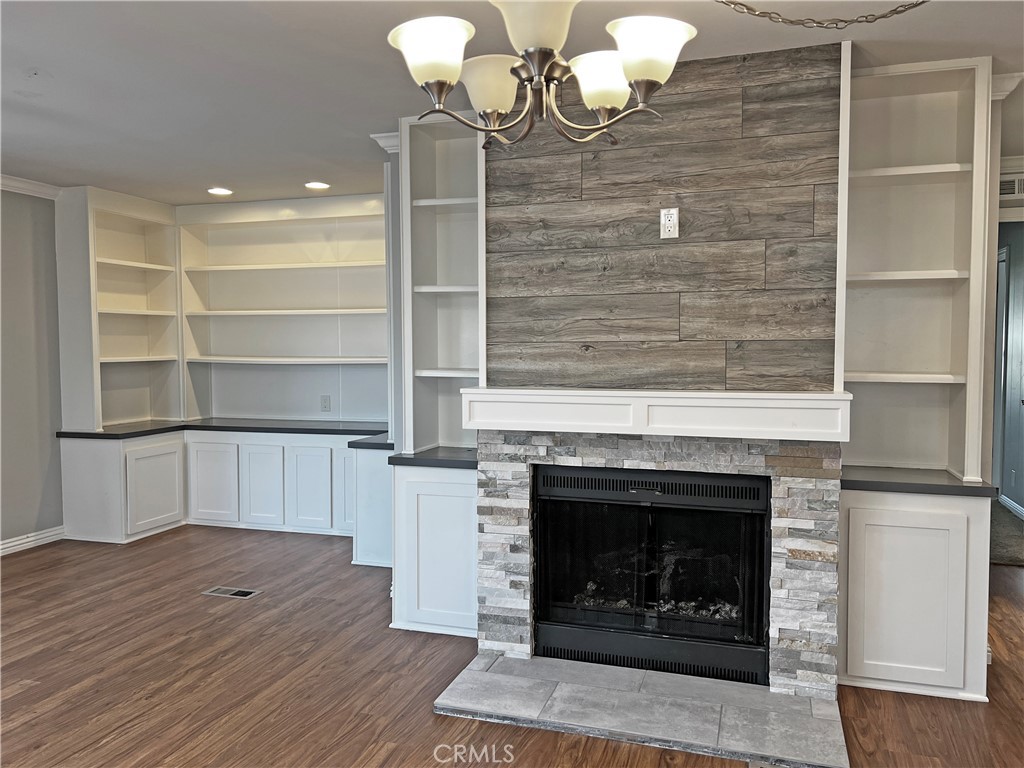 1352 Silver Lake Place, Unit 87 Brea, CA 92821 - Photo 18 of 51 a living room with stainless steel appliances wooden floor and chandelier