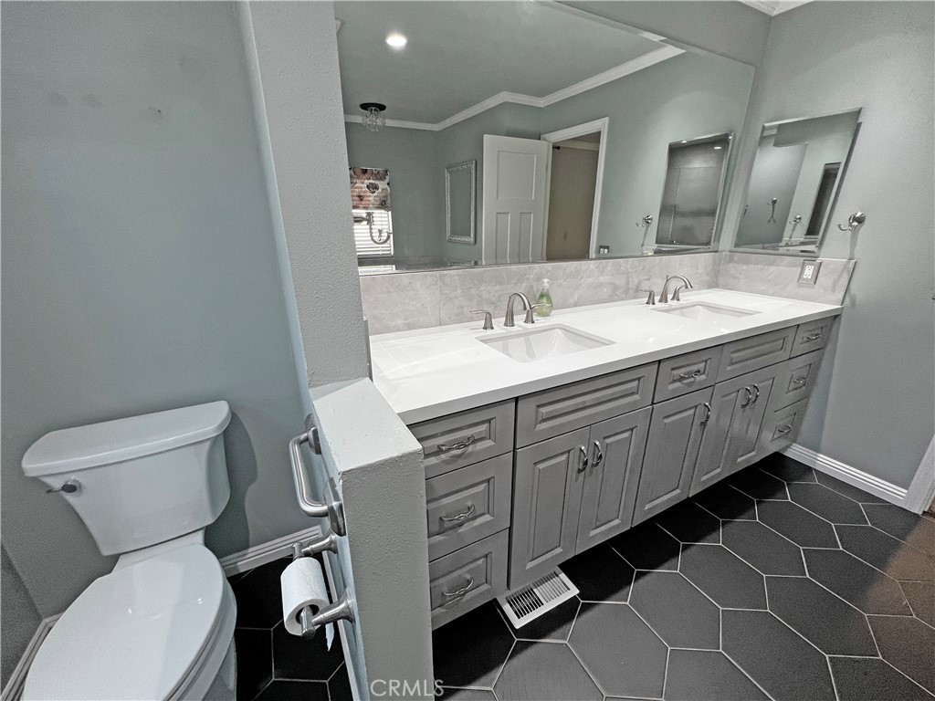 1352 Silver Lake Place, Unit 87 Brea, CA 92821 - Photo 27 of 51 a bathroom with a toilet sink and mirror