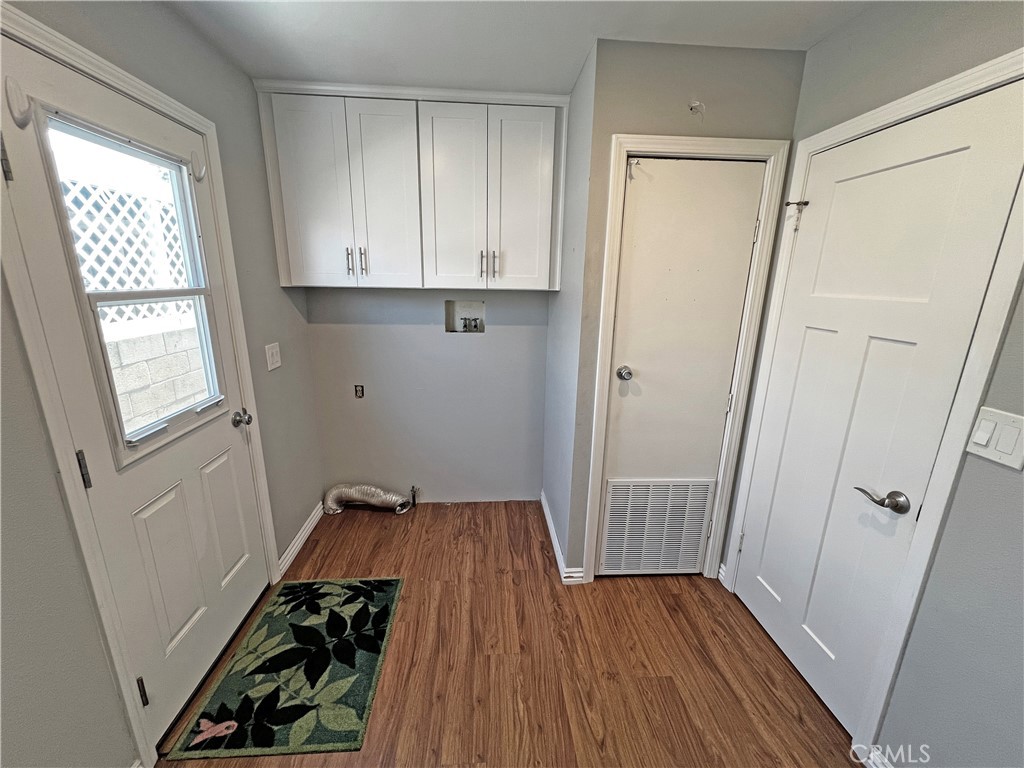 1352 Silver Lake Place, Unit 87 Brea, CA 92821 - Photo 34 of 51 a view of an empty room with wooden floor and a window