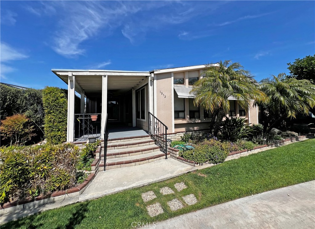 1352 Silver Lake Place, Unit 87 Brea, CA 92821 - Photo 36 of 51 a view of a house with potted plants and a bench