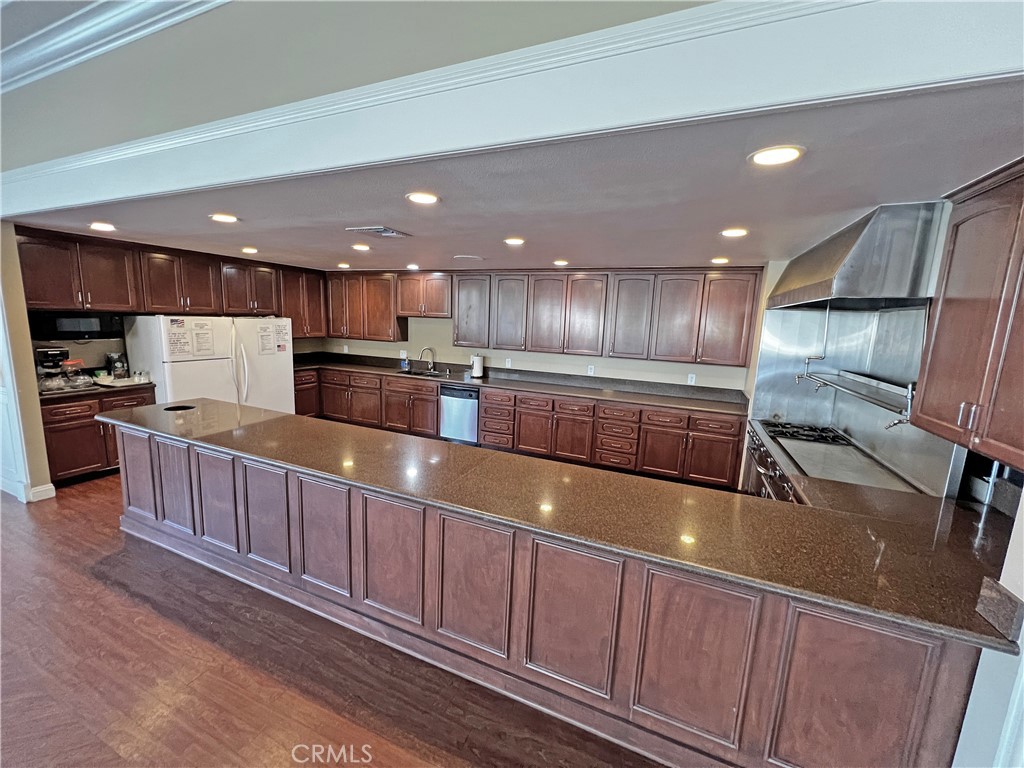 1352 Silver Lake Place, Unit 87 Brea, CA 92821 - Photo 47 of 51 a kitchen with stainless steel appliances wooden cabinets a refrigerator and a stove top oven