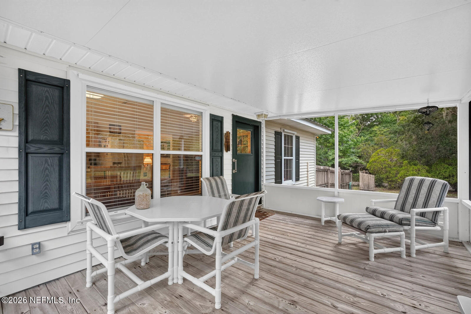1950 Lightsey Road St. Augustine, FL 32084 - Photo 28 of 57 a view of a dining room with furniture large windows and wooden floor