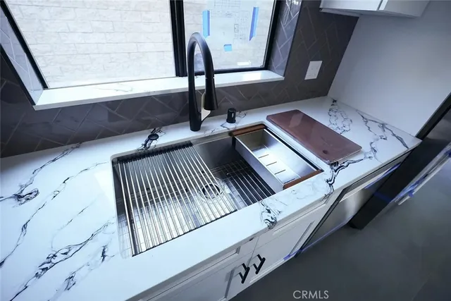 a kitchen with stainless steel appliances granite countertop a sink and a granite counter tops