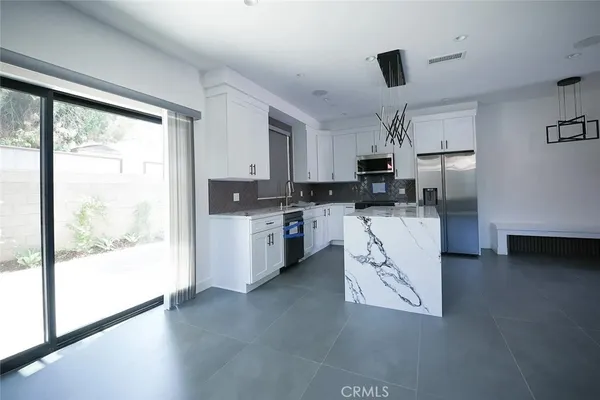 a view of a kitchen with an entryway and a window