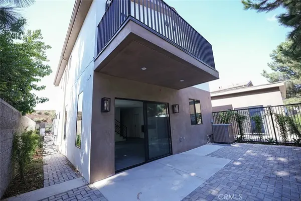 a view of a hallway with entryway and stairs