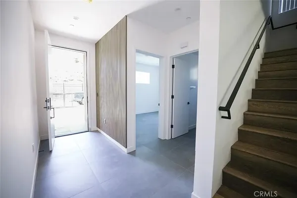 a kitchen with white cabinets and appliances
