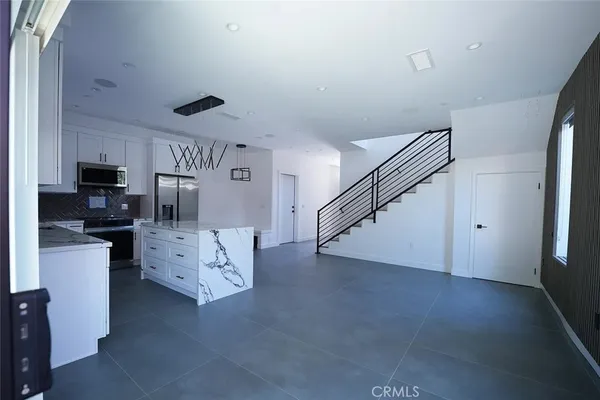a kitchen with a sink appliances and cabinets