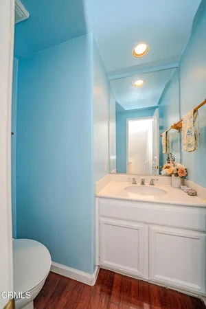 a view of bathroom with a sink and mirror