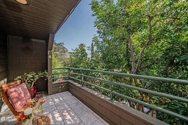 a view of a balcony with furniture