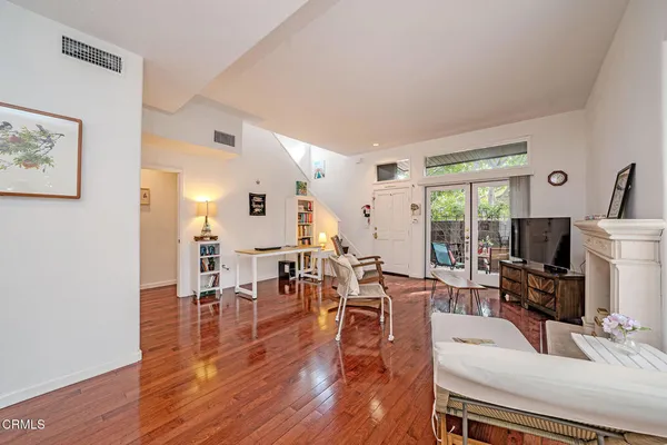 a living room with lots of furniture a fireplace and a flat screen tv