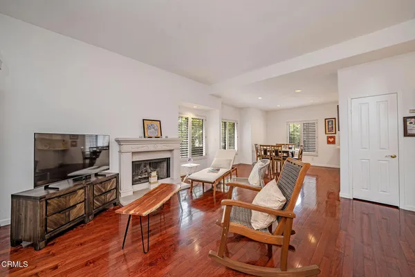 a living room with furniture a flat screen tv and a fireplace