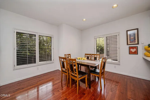 a view of a dining room with furniture and windows