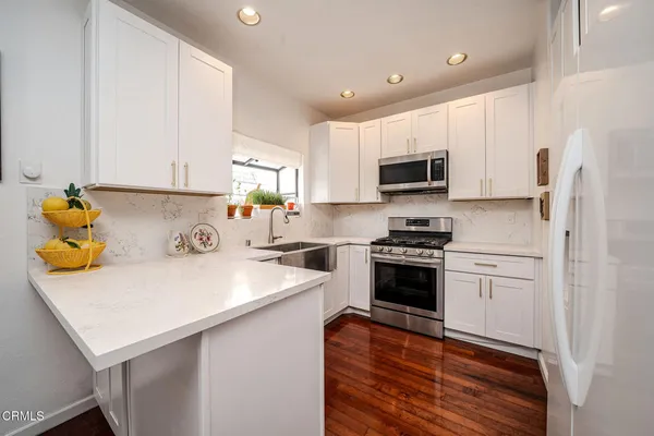 a kitchen with a sink a stove and refrigerator