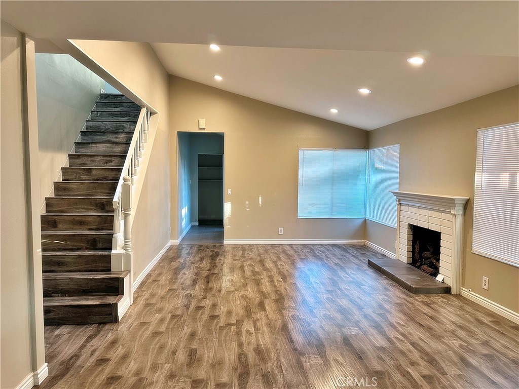 14911 Doheny Circle Irvine, CA 92604 - Photo 3 of 10 a view of empty room with wooden floor and fireplace
