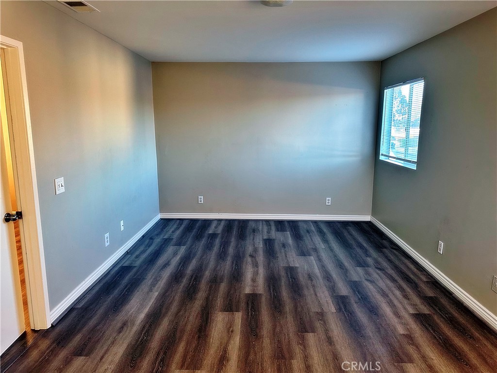 14911 Doheny Circle Irvine, CA 92604 - Photo 8 of 10 a view of a room with wooden floor and window
