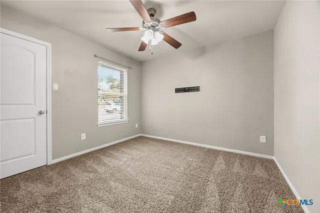 a bathroom with a granite countertop sink a toilet and shower