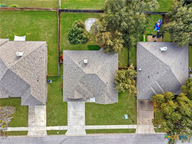 an aerial view of a house with a garden and a yard