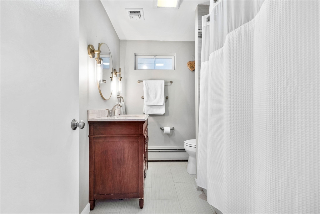 10 Marie Avenue Stoneham, MA 02180 - Photo 19 of 41 a bathroom with a sink a toilet and shower