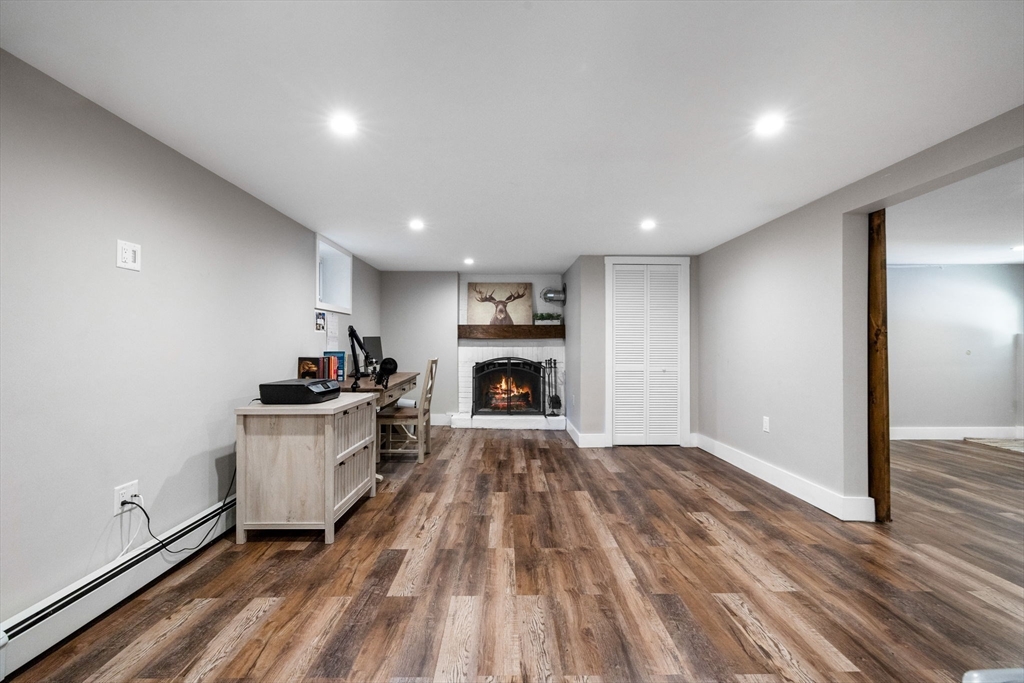 10 Marie Avenue Stoneham, MA 02180 - Photo 22 of 41 a living room with furniture and a fireplace