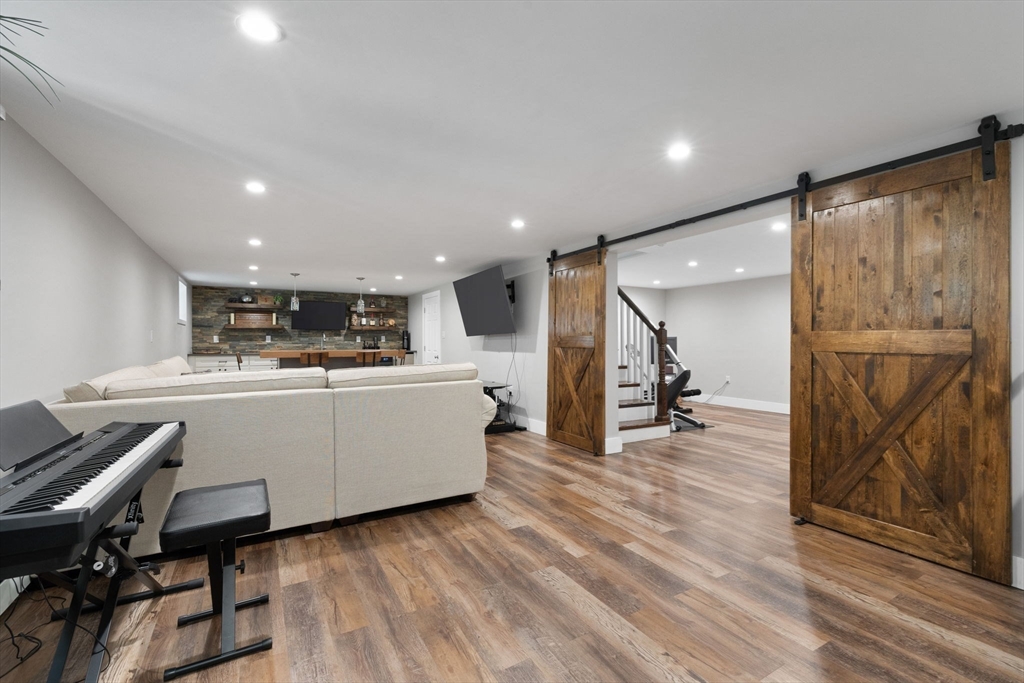 10 Marie Avenue Stoneham, MA 02180 - Photo 24 of 41 a living room with furniture and a flat screen tv
