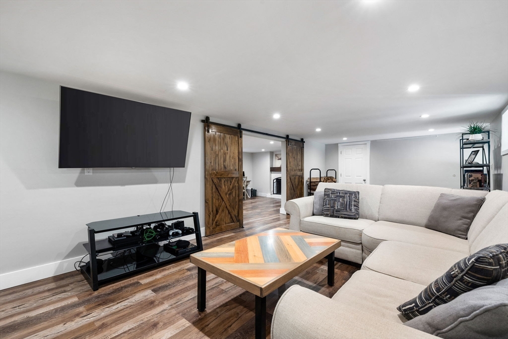 10 Marie Avenue Stoneham, MA 02180 - Photo 25 of 41 a living room with furniture and a flat screen tv