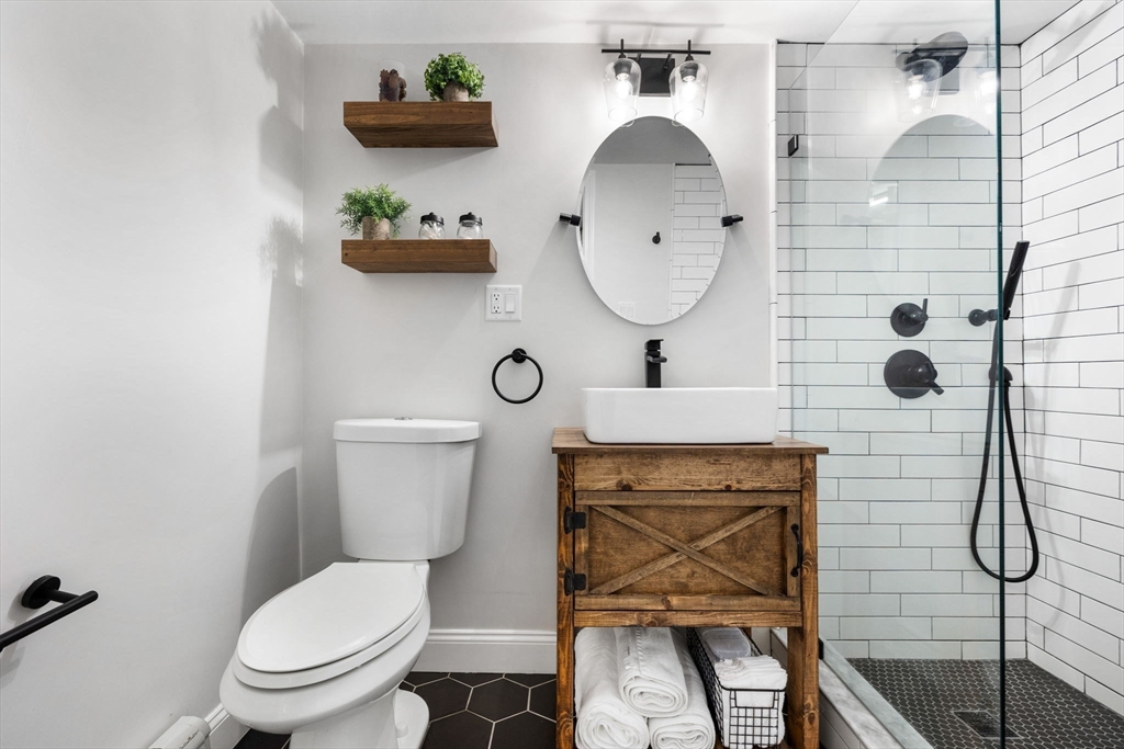 10 Marie Avenue Stoneham, MA 02180 - Photo 30 of 41 a bathroom with a toilet sink vanity shower and mirror