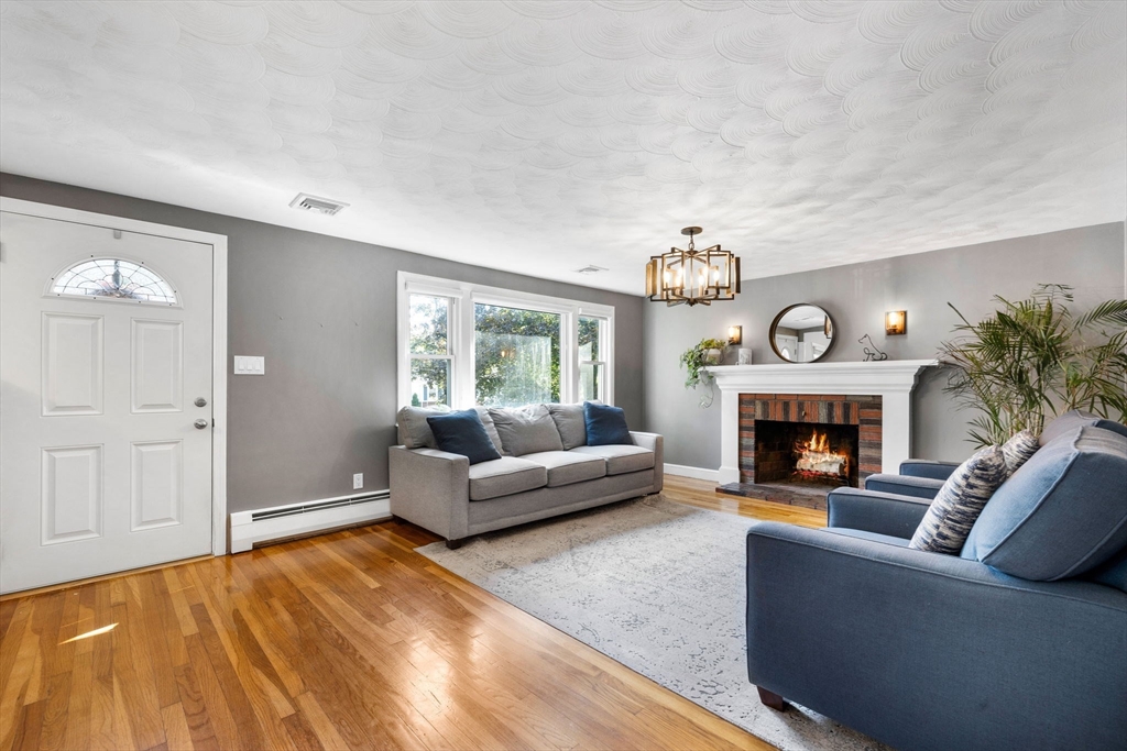 10 Marie Avenue Stoneham, MA 02180 - Photo 3 of 41 a living room with furniture a clock and a fireplace