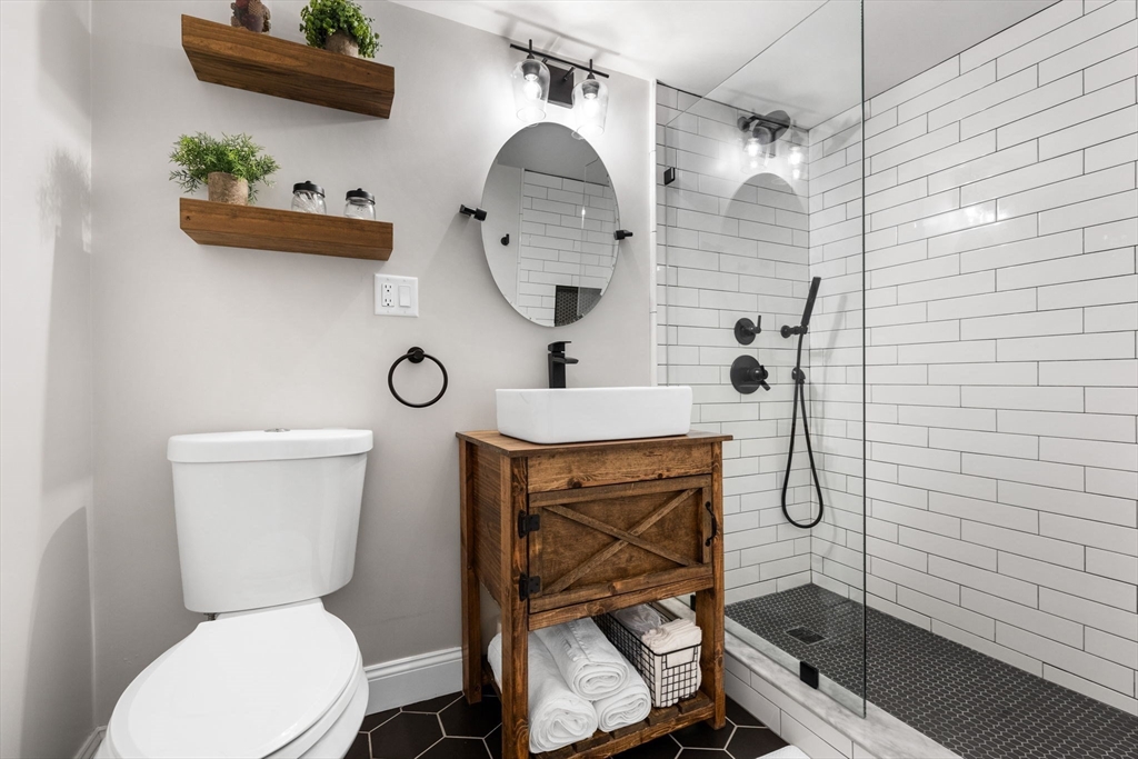 10 Marie Avenue Stoneham, MA 02180 - Photo 31 of 41 a bathroom with a toilet sink and mirror