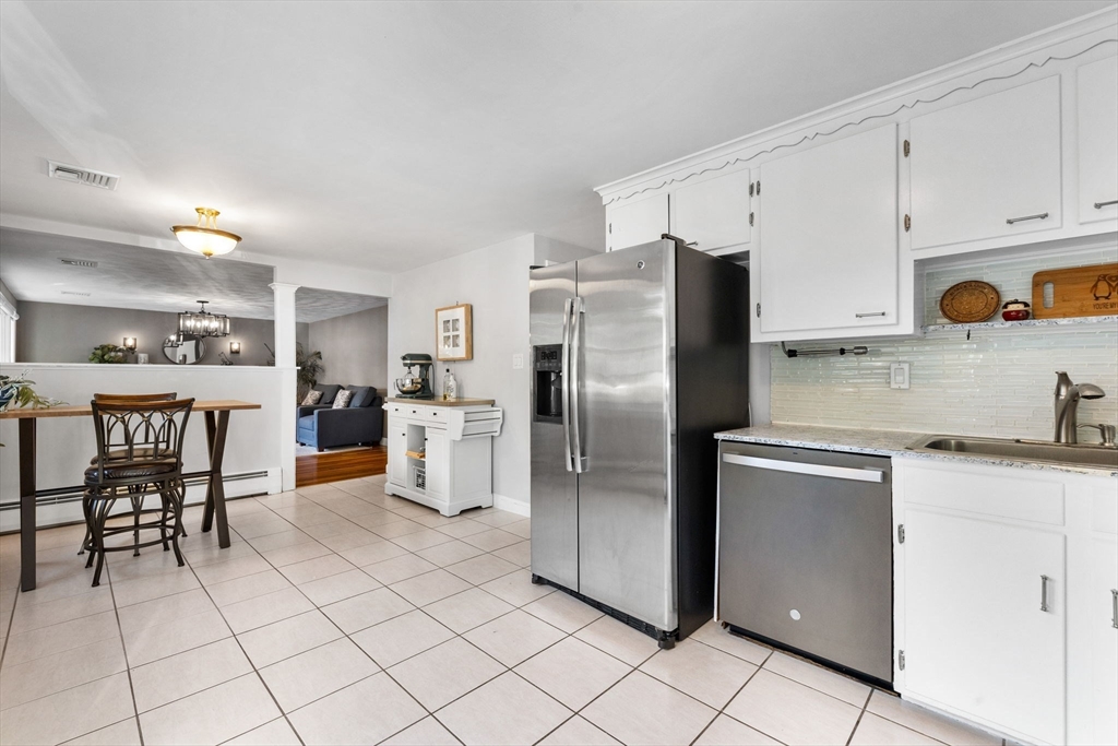 10 Marie Avenue Stoneham, MA 02180 - Photo 6 of 41 a kitchen with stainless steel appliances granite countertop a refrigerator and a stove top oven