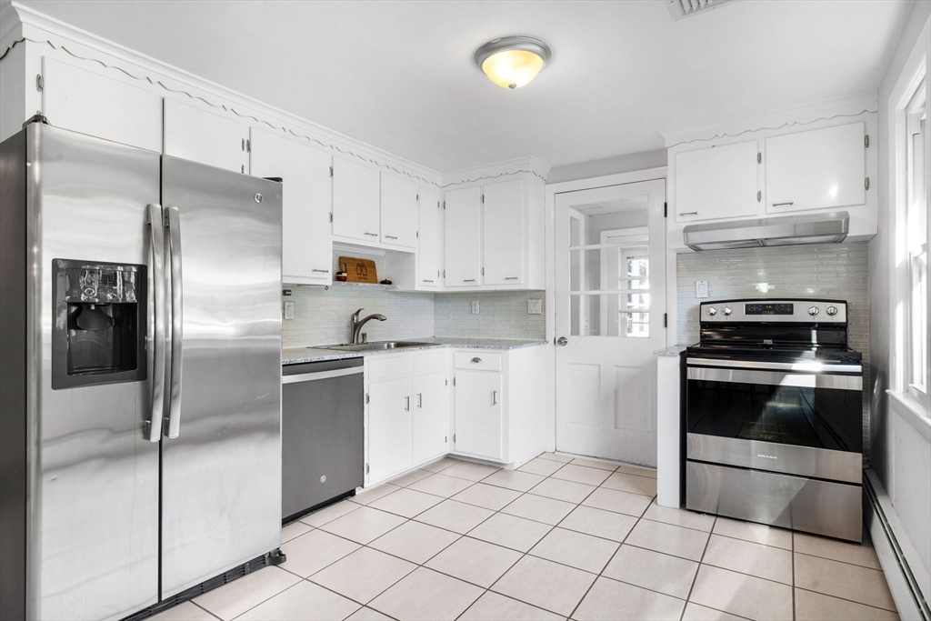 10 Marie Avenue Stoneham, MA 02180 - Photo 8 of 41 a kitchen with white cabinets and stainless steel appliances