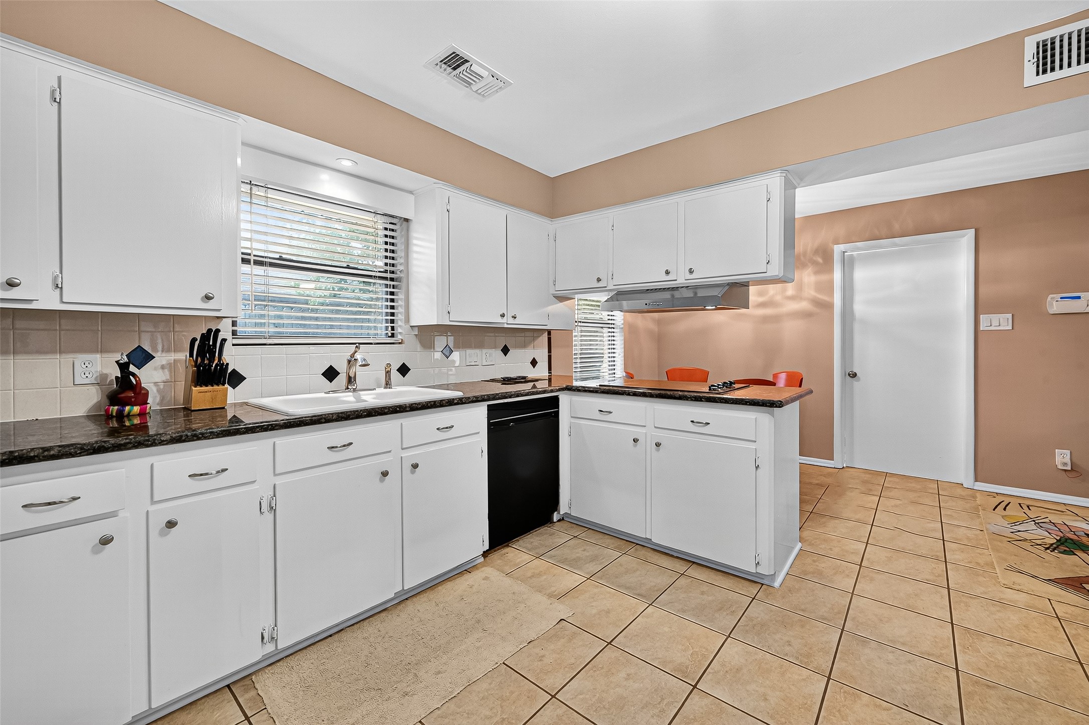 5734 Sanford Road Houston, TX 77096 - Photo 13 of 48 a kitchen with granite countertop white cabinets and white appliances