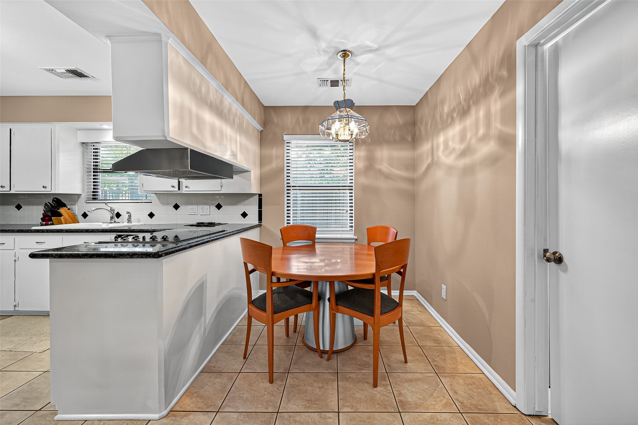 5734 Sanford Road Houston, TX 77096 - Photo 14 of 48 a kitchen with stainless steel appliances a dining table chairs and chandelier