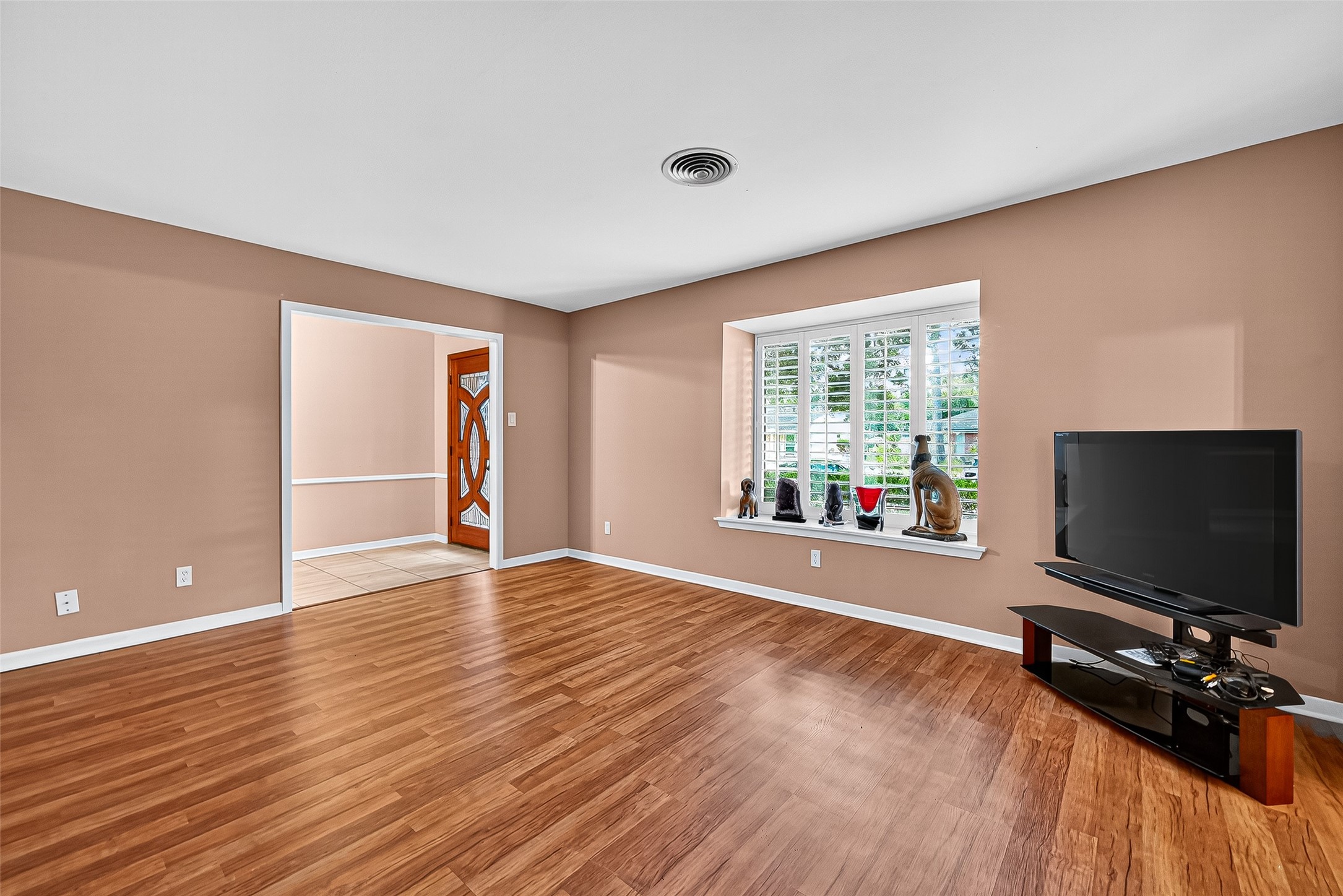 5734 Sanford Road Houston, TX 77096 - Photo 21 of 48 an empty room with wooden floor and windows
