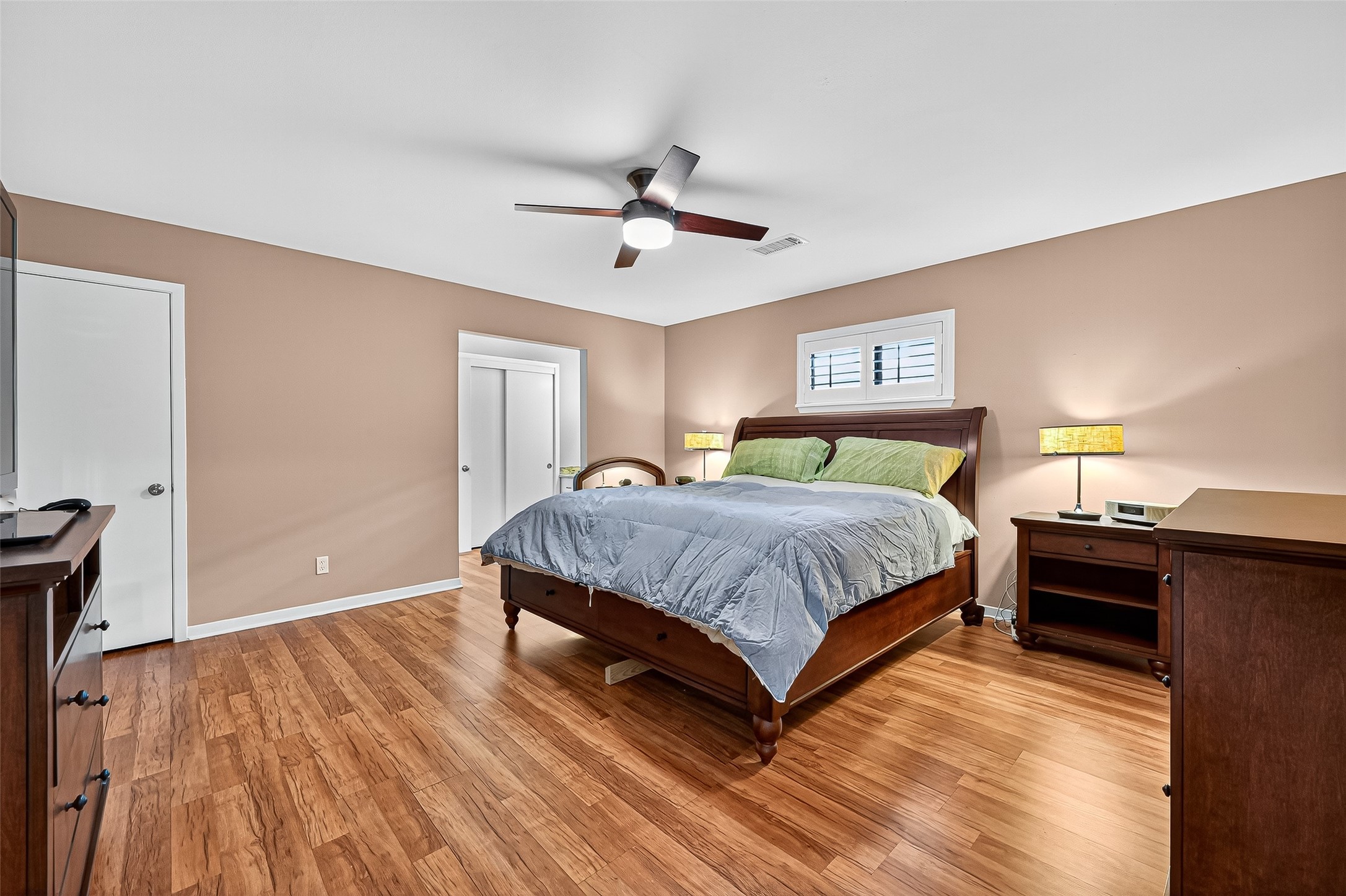 5734 Sanford Road Houston, TX 77096 - Photo 25 of 48 a bedroom with a bed and wooden floor