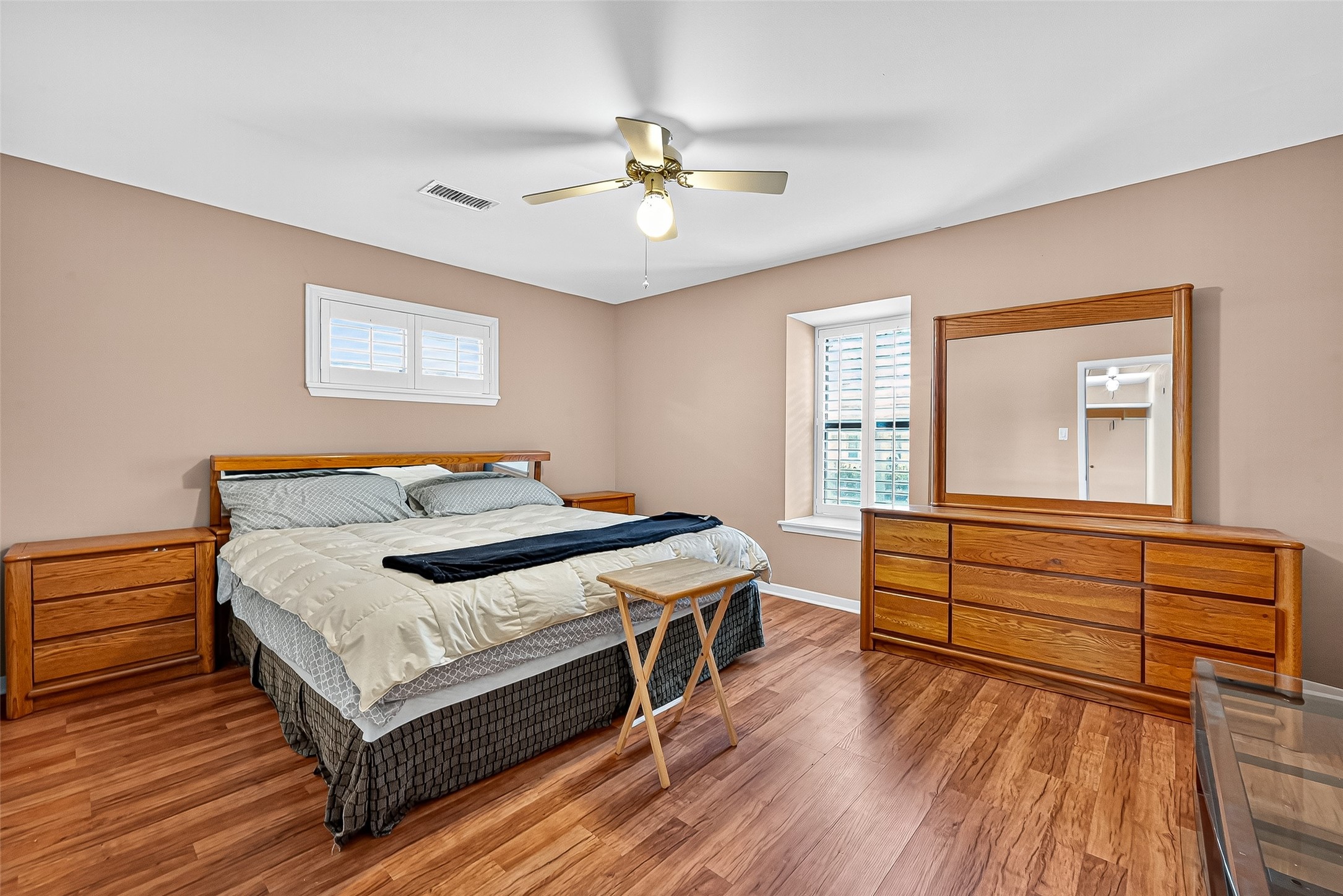5734 Sanford Road Houston, TX 77096 - Photo 27 of 48 a bedroom with a bed and a dresser with wooden floor