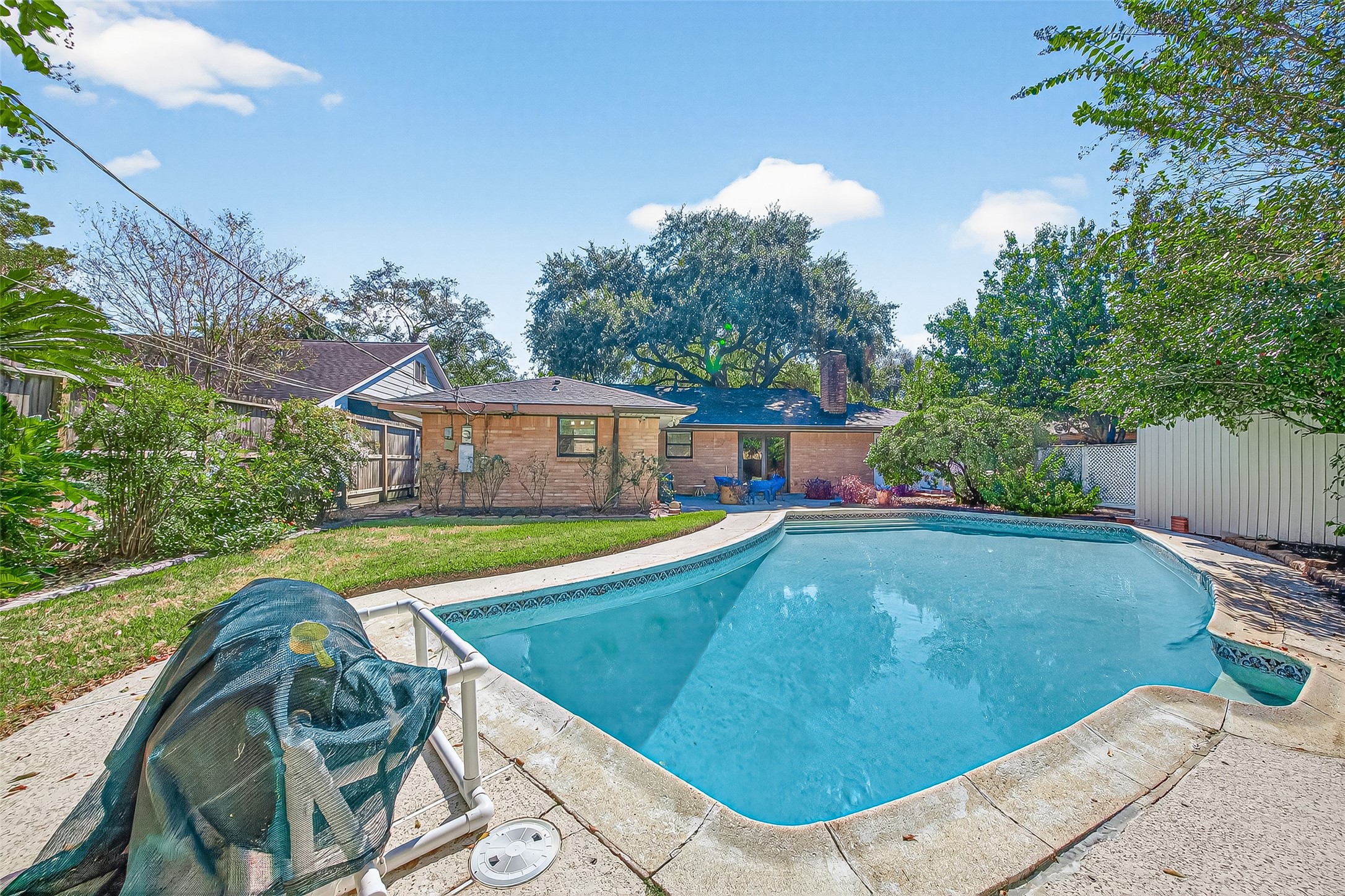 5734 Sanford Road Houston, TX 77096 - Photo 37 of 48 a view of a swimming pool with a patio and a yard