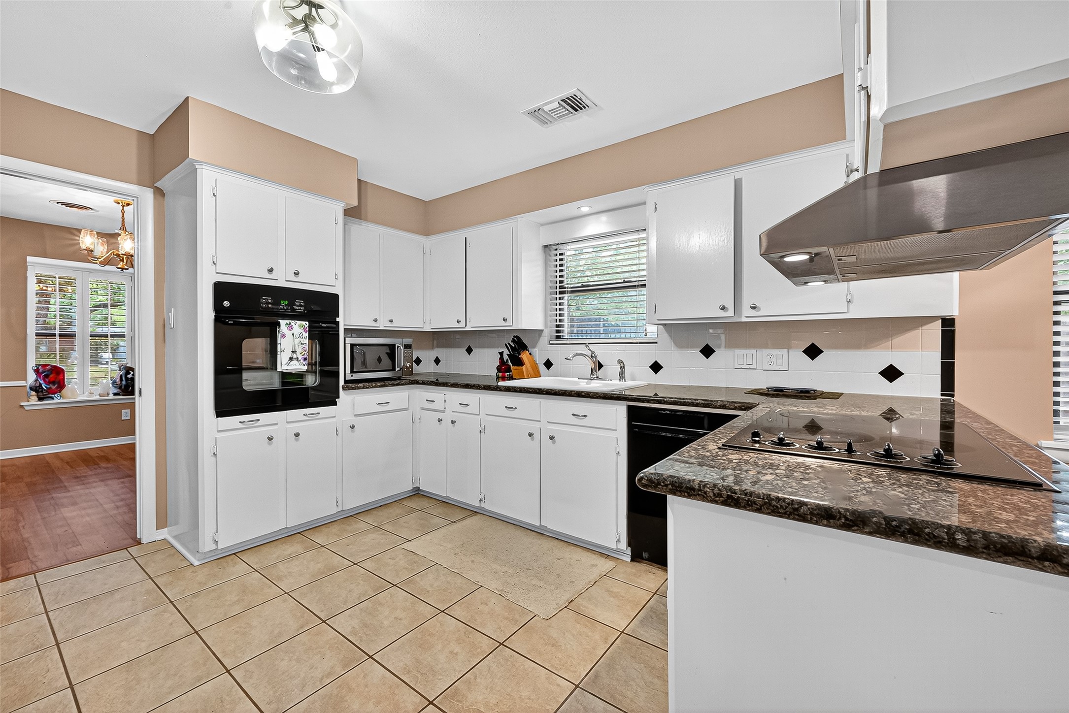 5734 Sanford Road Houston, TX 77096 - Photo 9 of 48 a kitchen with granite countertop white cabinets and white appliances