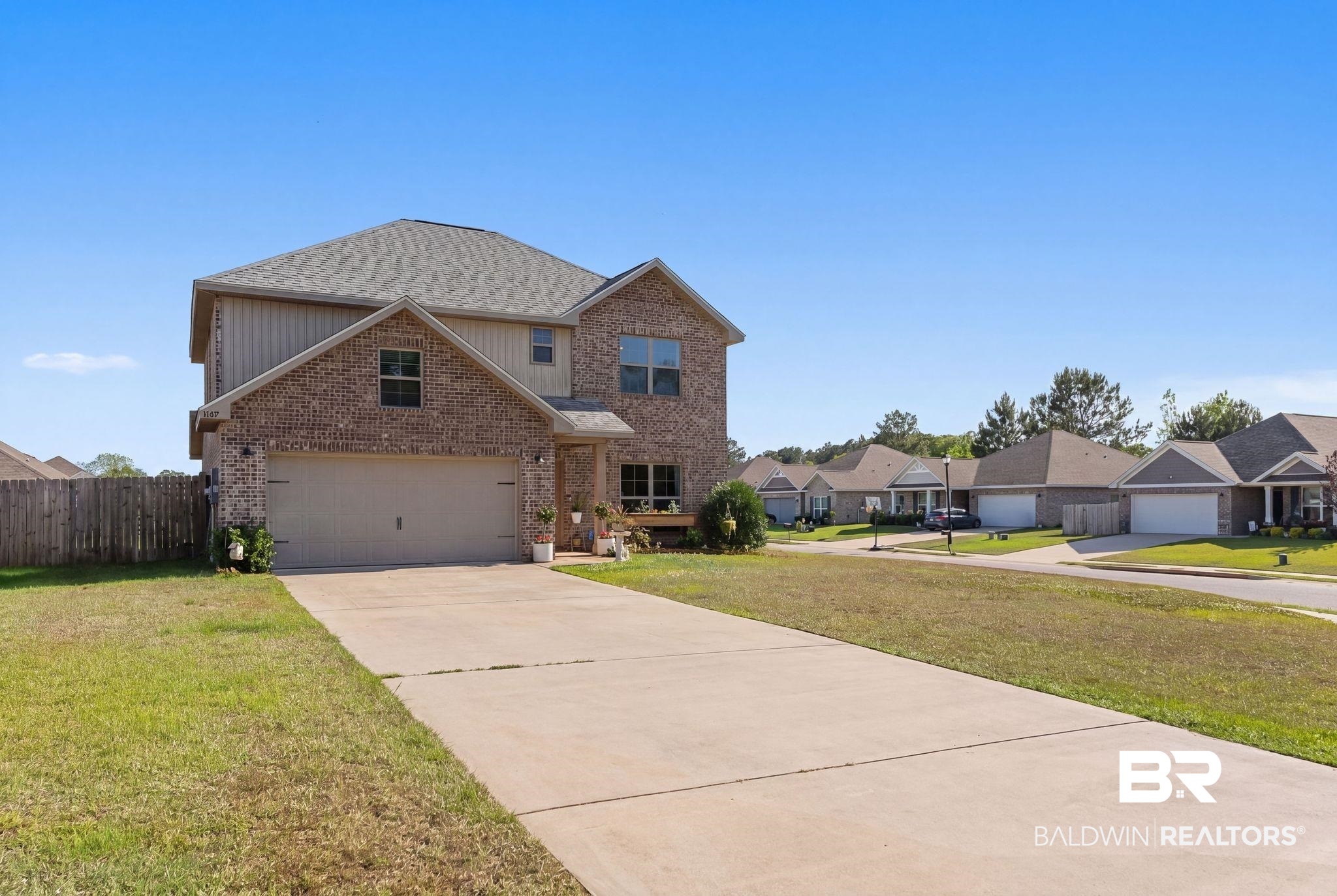 16607 Prado Loop Loxley, AL 36551 - Photo 2 of 46 Two-story home featuring brick and siding exterior, an attached two-car garage, and a concrete driveway
