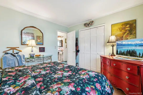a bedroom with bed and wooden floor