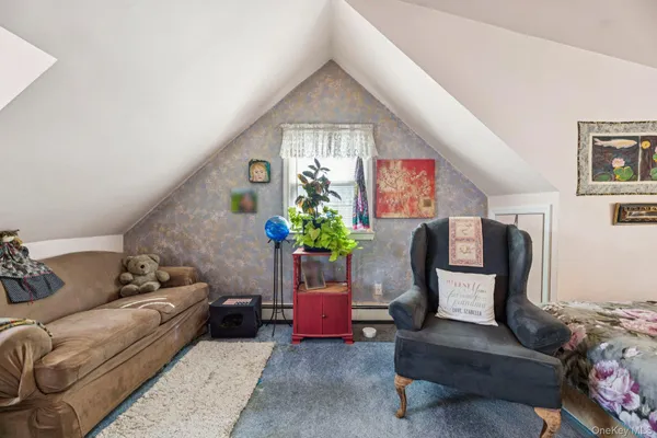 a living room with furniture fireplace and a potted plant