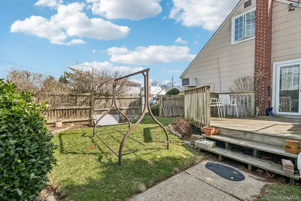 a view of backyard with wooden stairs
