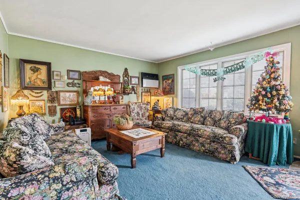 a living room with furniture and a floor to ceiling window